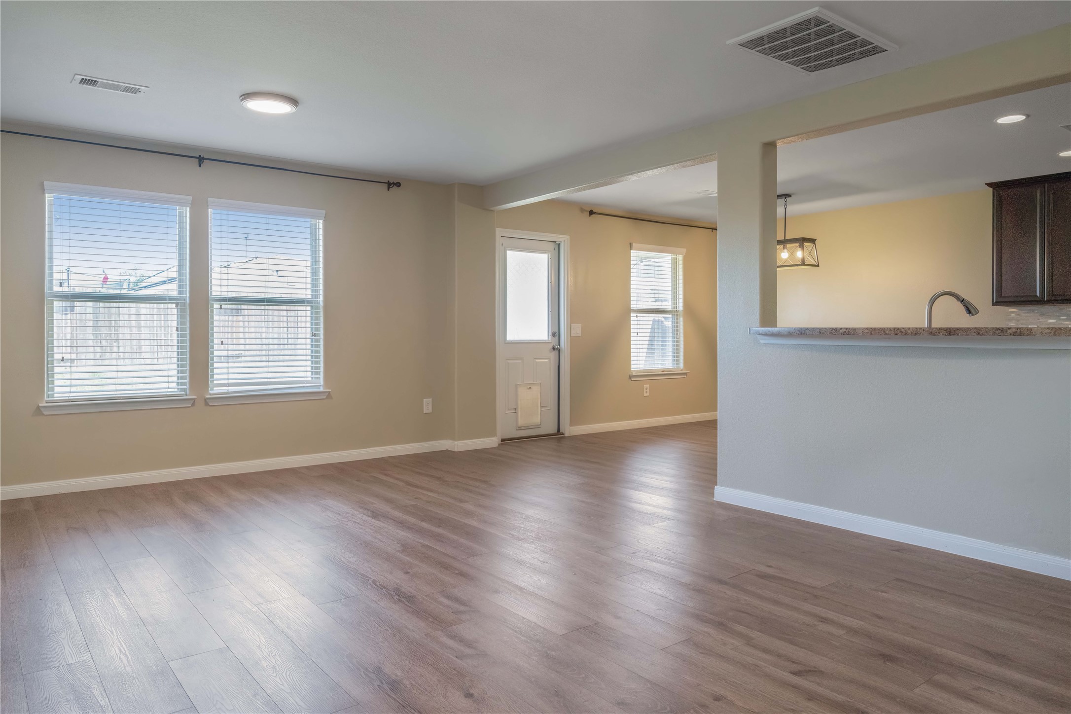 10011 Orchid Spring Lane Houston, TX 77044 - Photo 8 of 42 an empty room with wooden floor and windows