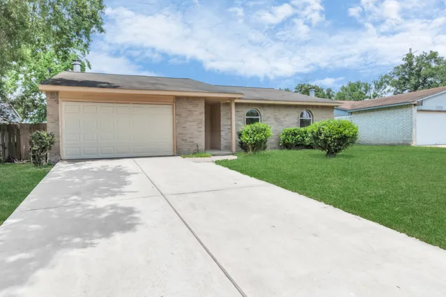 a front view of house with yard and trees