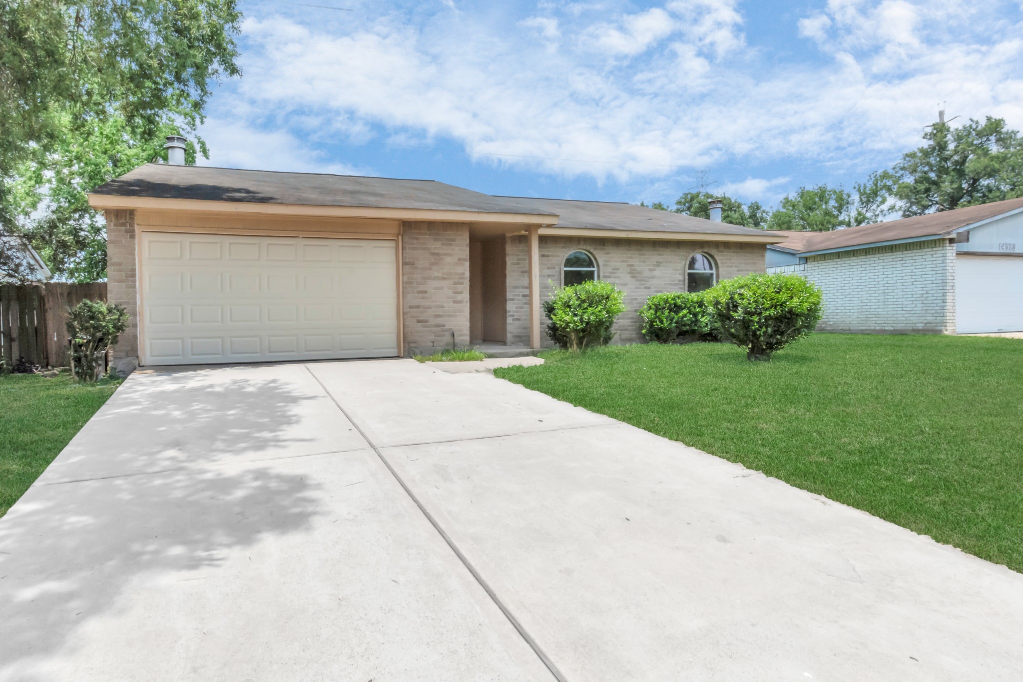 14519 Edenglen Drive Houston, TX 77049 - Photo 1 of 32 a front view of house with yard and trees
