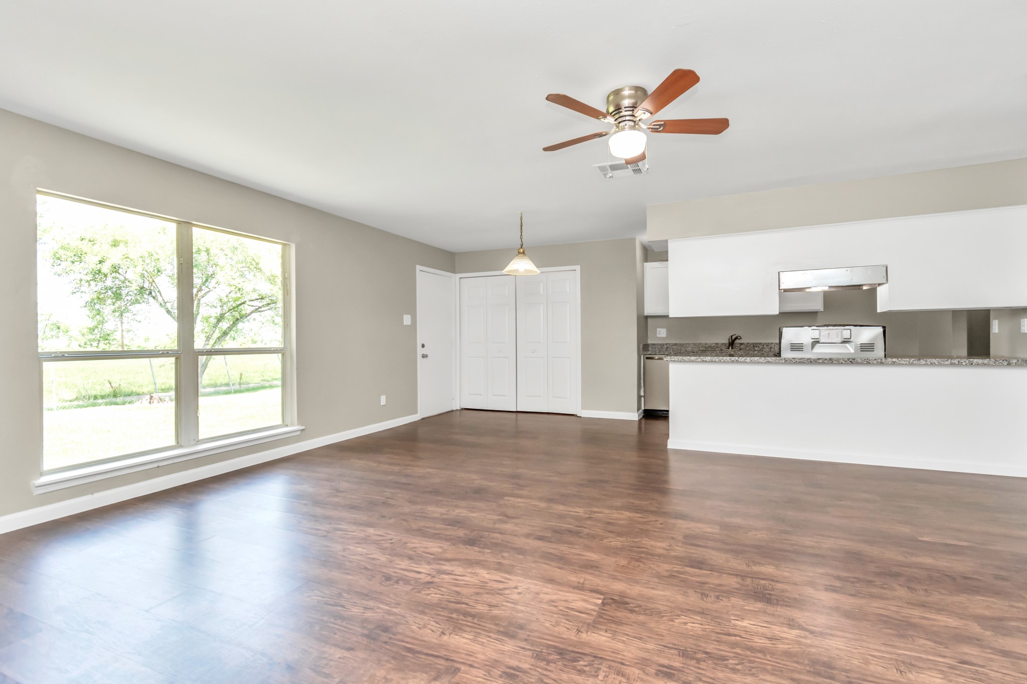14519 Edenglen Drive Houston, TX 77049 - Photo 12 of 32 a view of empty room with wooden floor and ceiling fan