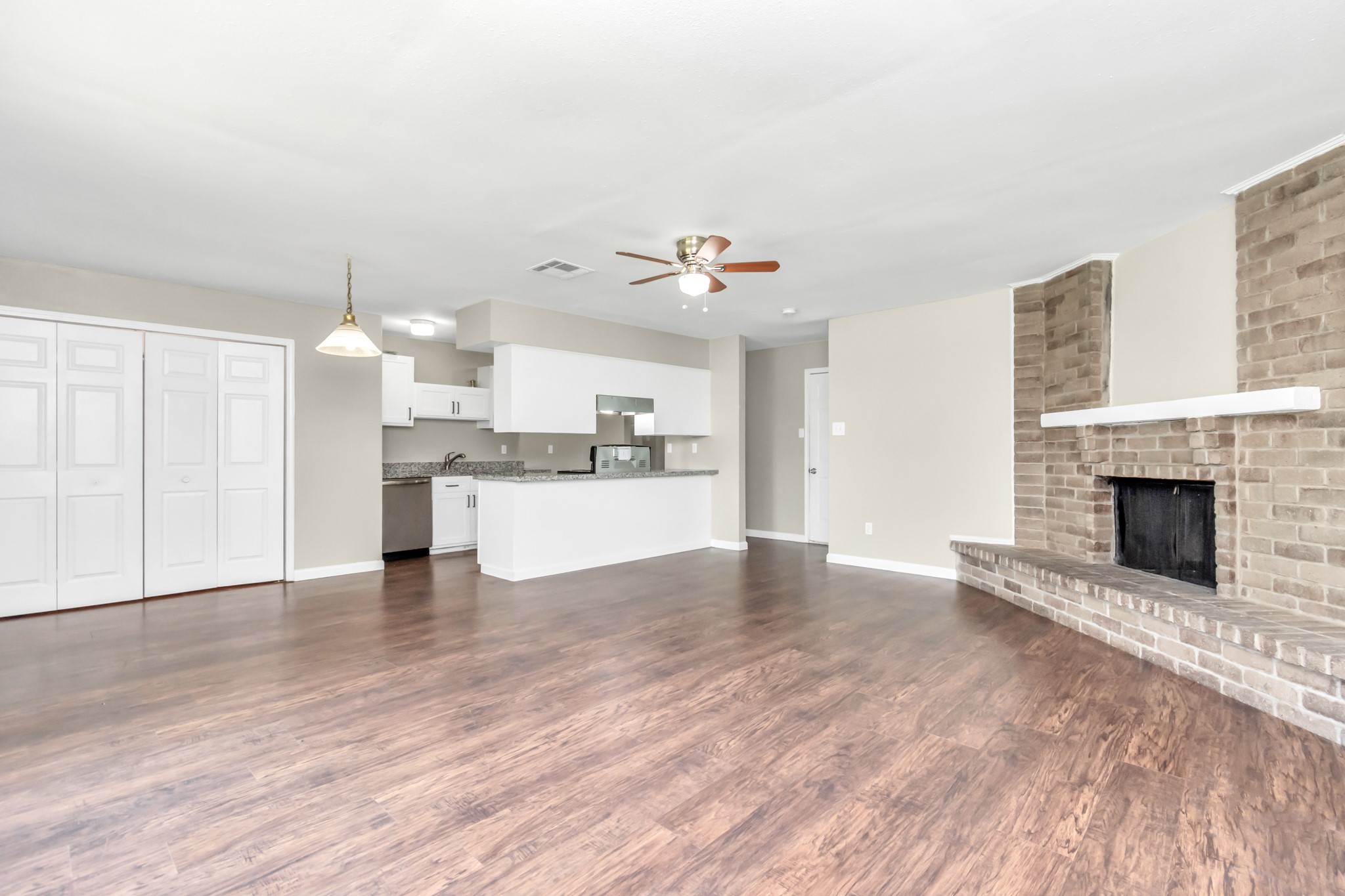 14519 Edenglen Drive Houston, TX 77049 - Photo 13 of 32 a view of a kitchen with an empty space and a fireplace