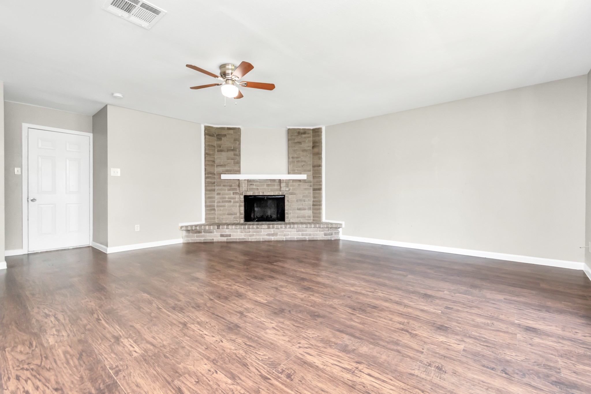 14519 Edenglen Drive Houston, TX 77049 - Photo 14 of 32 a view of empty room with wooden floor and ceiling fan