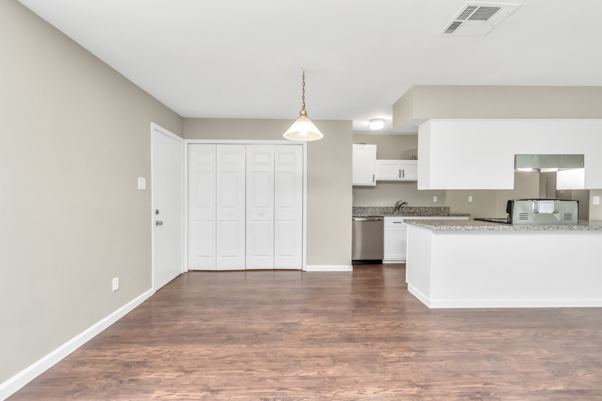 14519 Edenglen Drive Houston, TX 77049 - Photo 17 of 32 a kitchen with granite countertop a stove a sink and a refrigerator