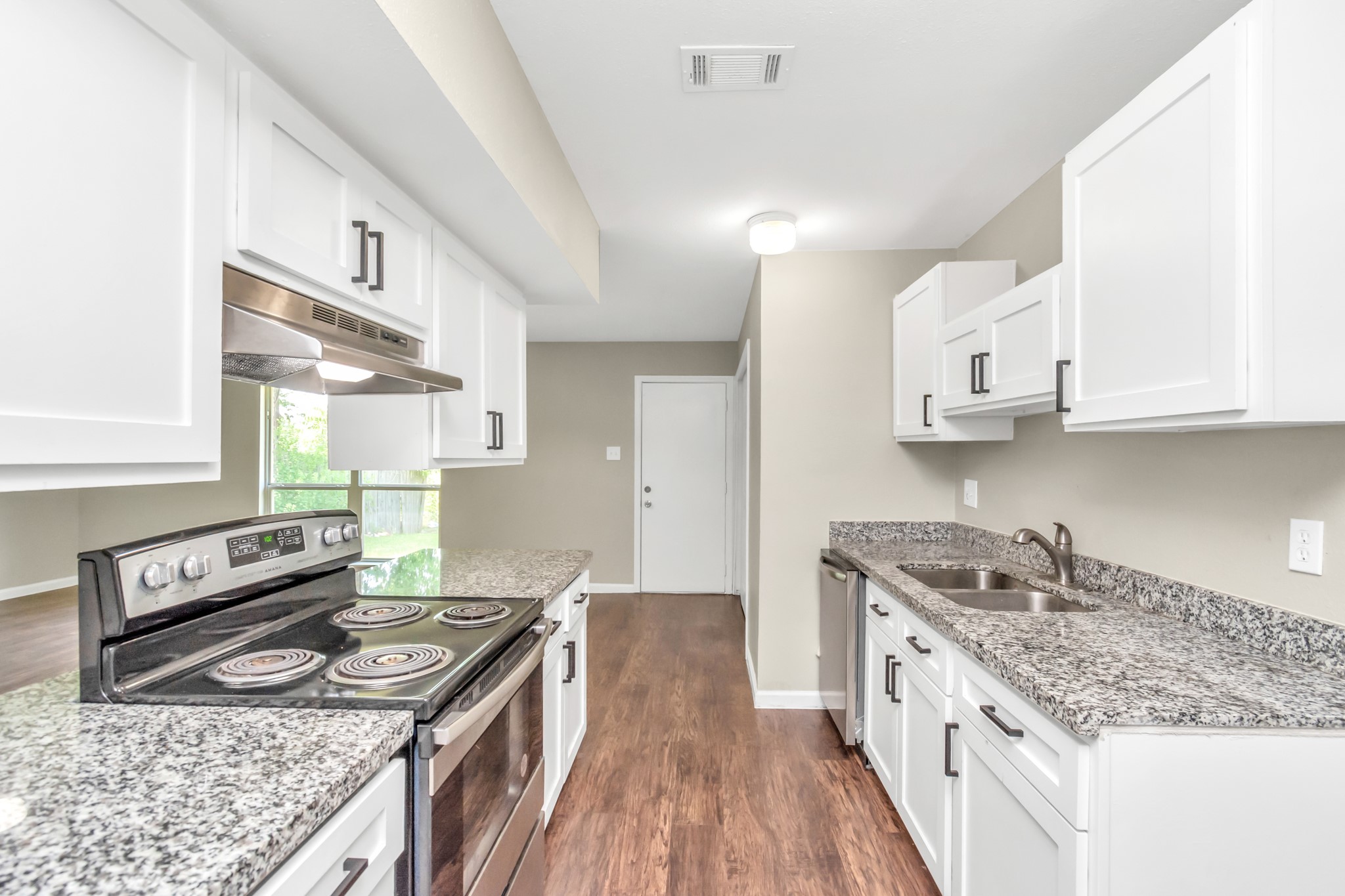 14519 Edenglen Drive Houston, TX 77049 - Photo 19 of 32 a kitchen with stainless steel appliances granite countertop a stove and a sink