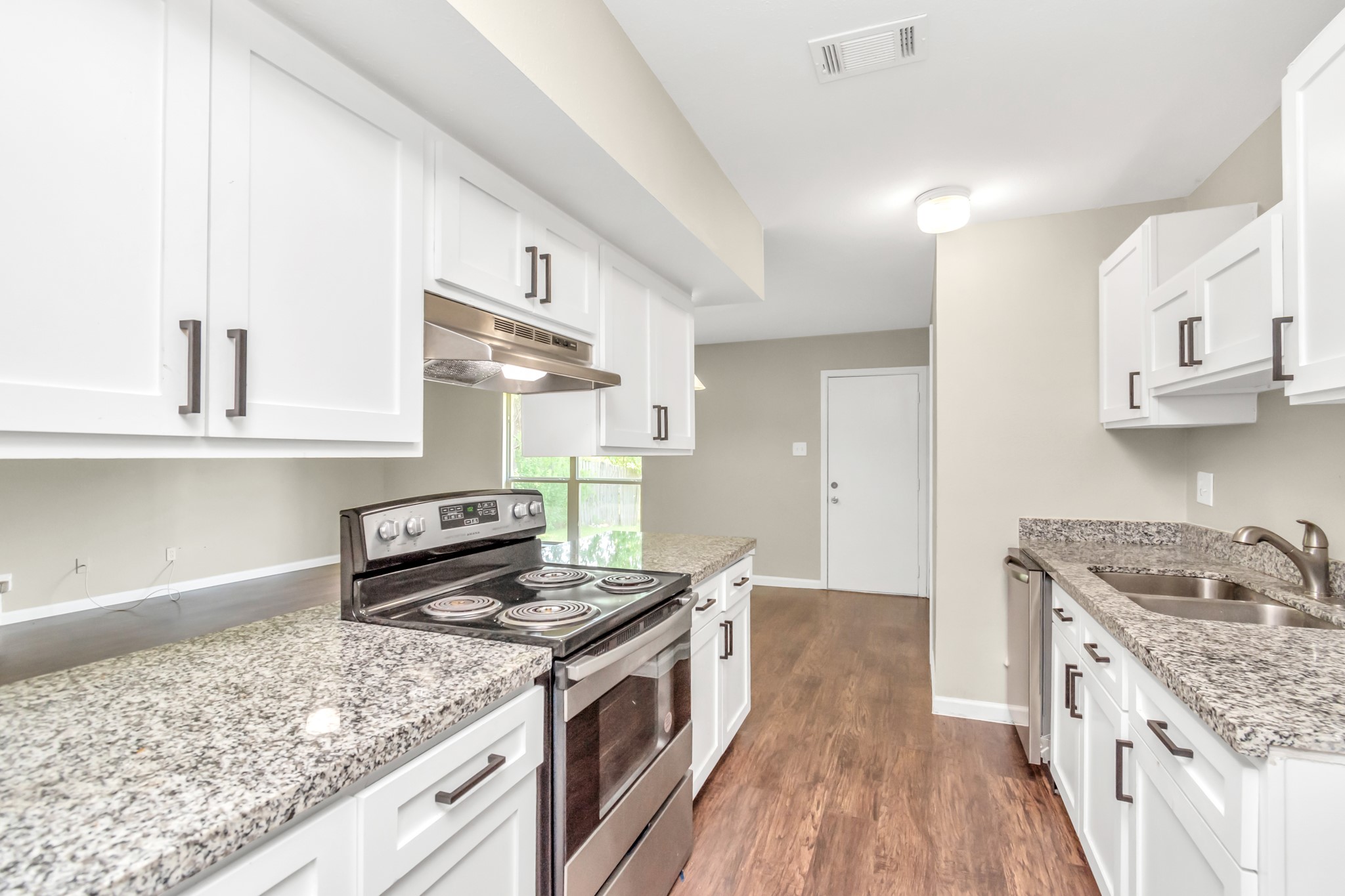 14519 Edenglen Drive Houston, TX 77049 - Photo 20 of 32 a kitchen with stainless steel appliances granite countertop a stove and a sink