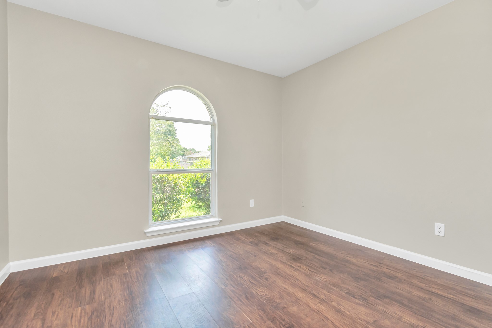 14519 Edenglen Drive Houston, TX 77049 - Photo 21 of 32 an empty room with wooden floor and windows