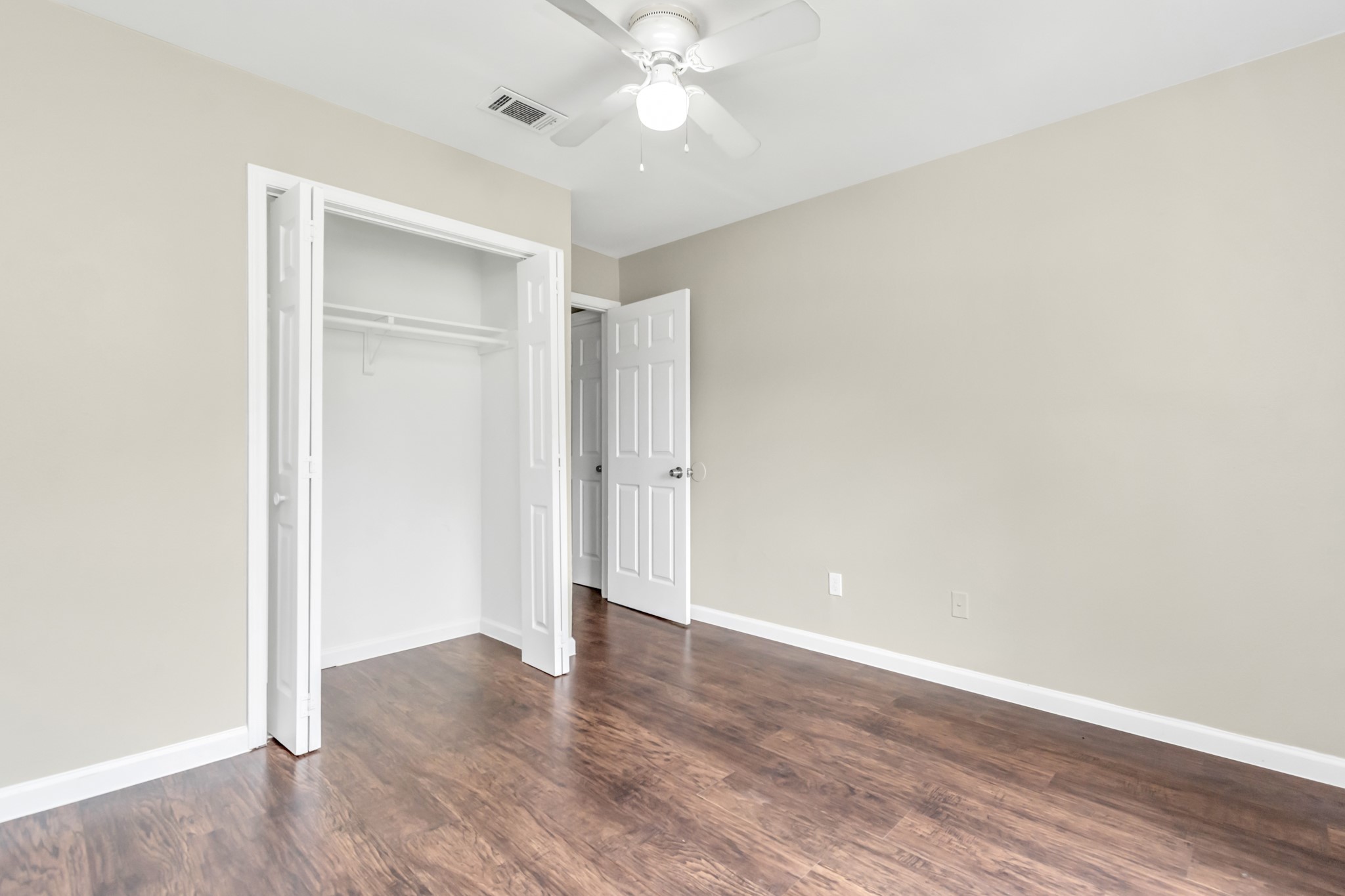 14519 Edenglen Drive Houston, TX 77049 - Photo 22 of 32 an empty room with wooden floor and a ceiling fan