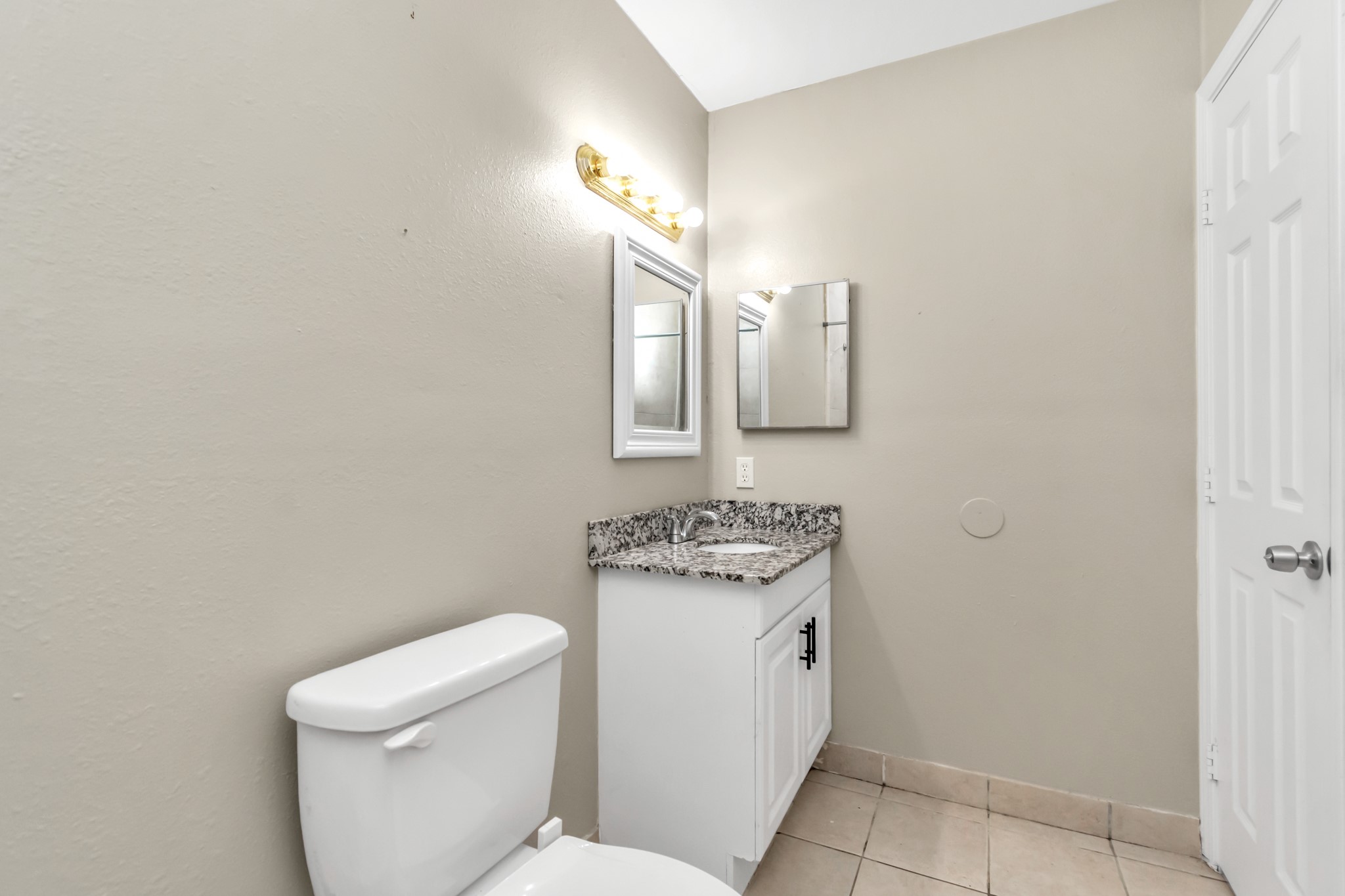 14519 Edenglen Drive Houston, TX 77049 - Photo 29 of 32 a bathroom with a toilet sink and mirror
