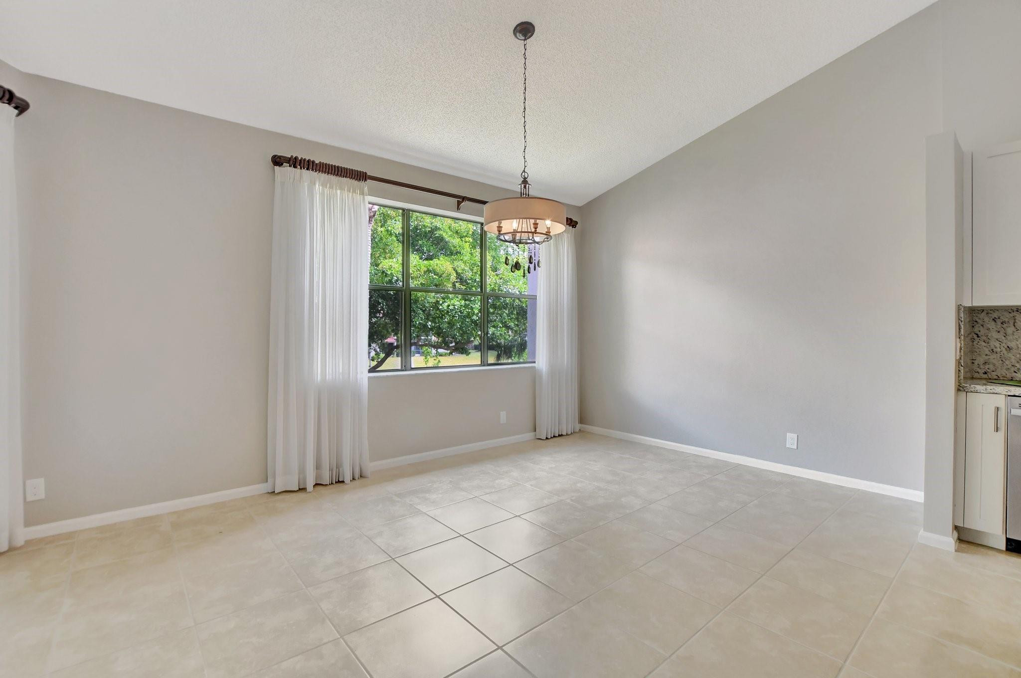 5801 Coach House Circle, Unit E Boca Raton, FL 33486 - Photo 34 of 41 Dining area with water views.