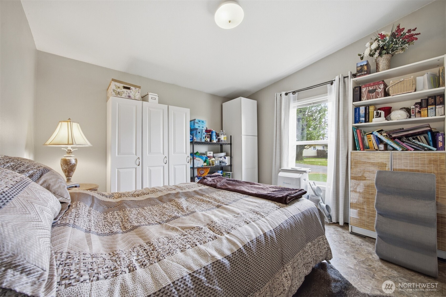 380 East Pole Road, Unit 6 Lynden, WA 98264 - Photo 28 of 40 a bedroom with a bed and a book shelf