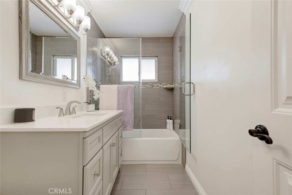 9350 Rhea Avenue Northridge, CA 91324 - Photo 7 of 20 a bathroom with a tub sink and mirror