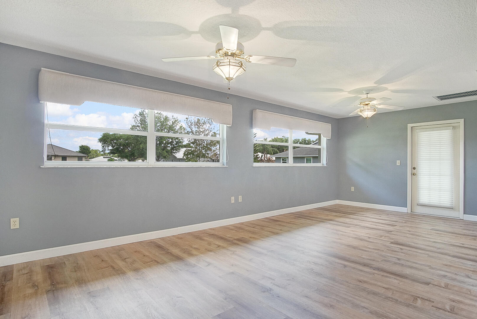 2321 Southwest 3rd Court Okeechobee, FL 34974 - Photo 14 of 37 a view of an empty room with wooden floor and a window