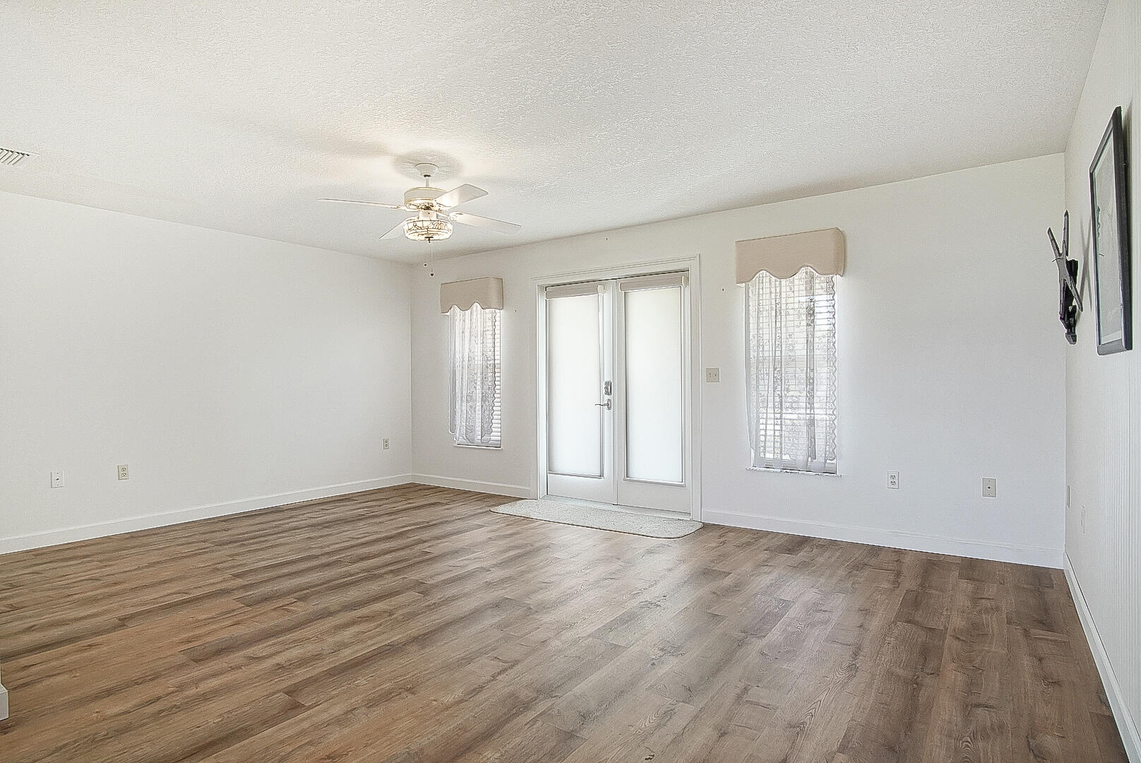 2321 Southwest 3rd Court Okeechobee, FL 34974 - Photo 27 of 35 wooden floor in an empty room with a window