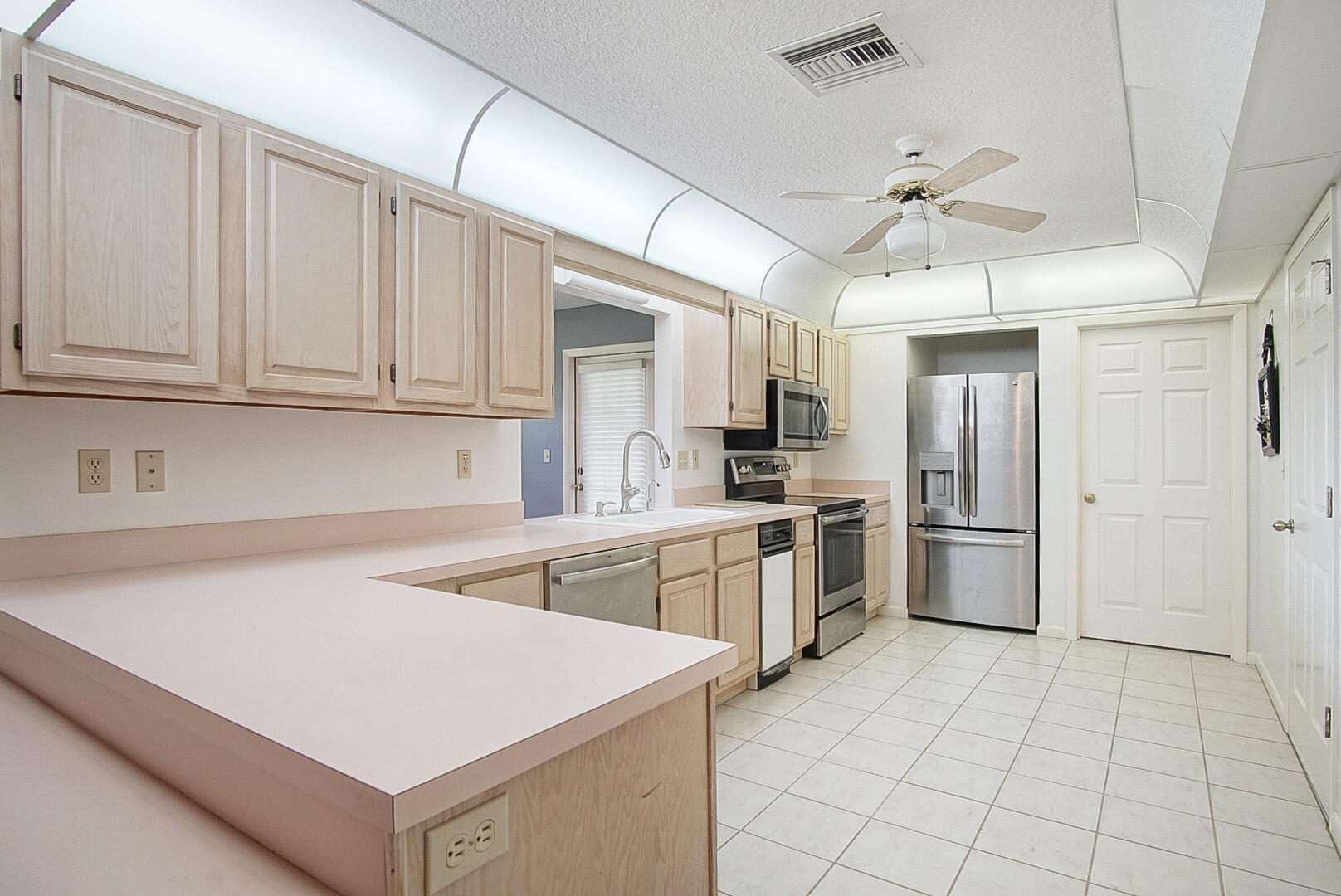 2321 Southwest 3rd Court Okeechobee, FL 34974 - Photo 27 of 37 a kitchen with a sink a counter top space stainless steel appliances and cabinets