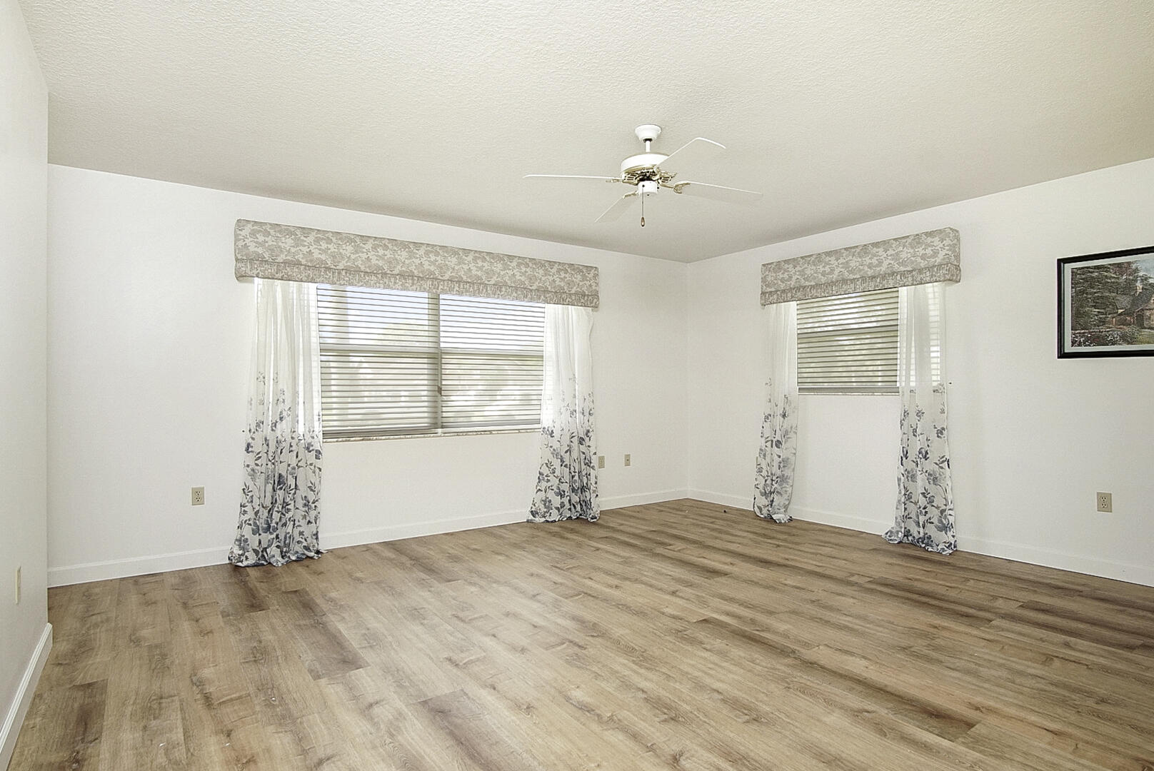 2321 Southwest 3rd Court Okeechobee, FL 34974 - Photo 5 of 37 a view of empty room with wooden floor and fan