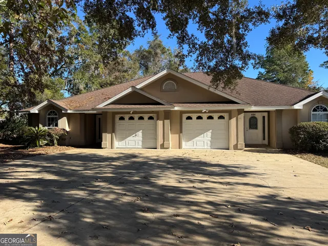a front view of a house with a garden