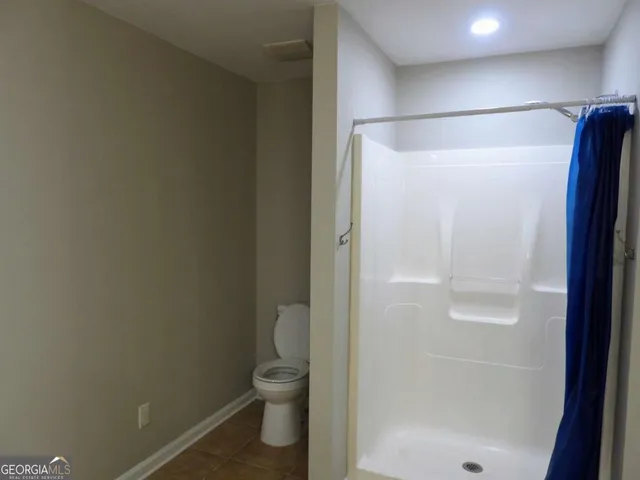 a bathroom with a shower and a toilet