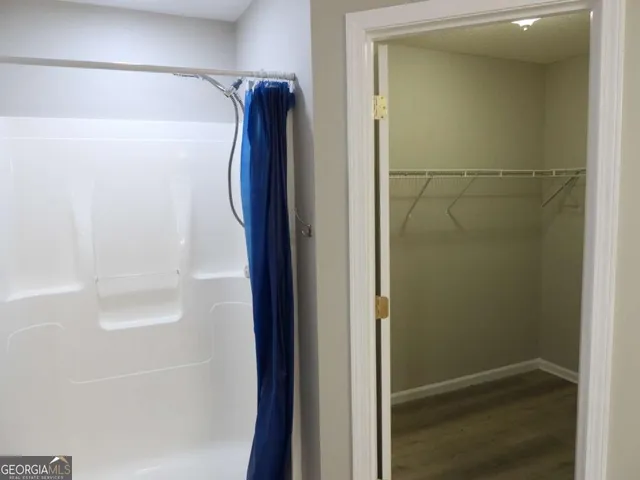 a bathroom with a shower and a sink