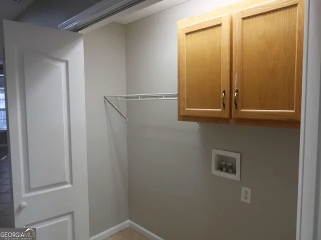 an empty room with a window and wooden floor