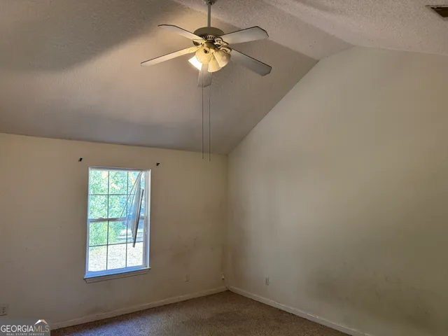 a room with pool table and windows