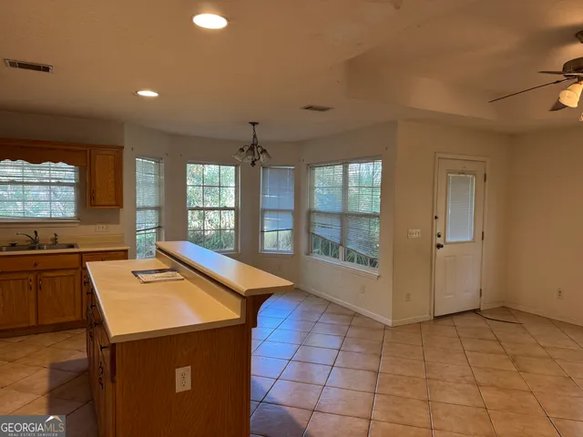 a kitchen with a sink stove and microwave