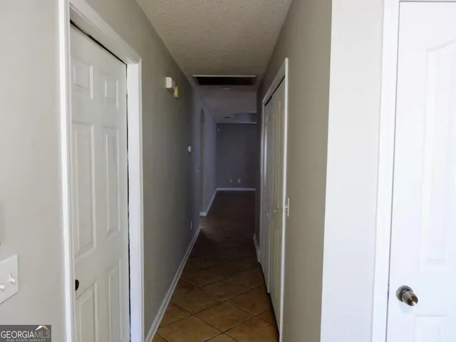 a view of a hallway with a wooden door