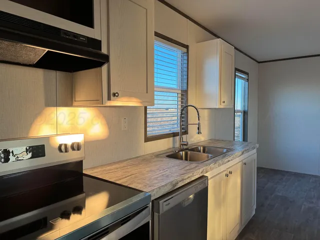 a utility room with a stove and a refrigerator