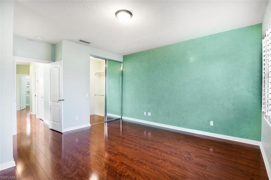 5721 Cove Circle, Unit 36 Naples, FL 34119 - Photo 11 of 32 a view of empty room with wooden floor