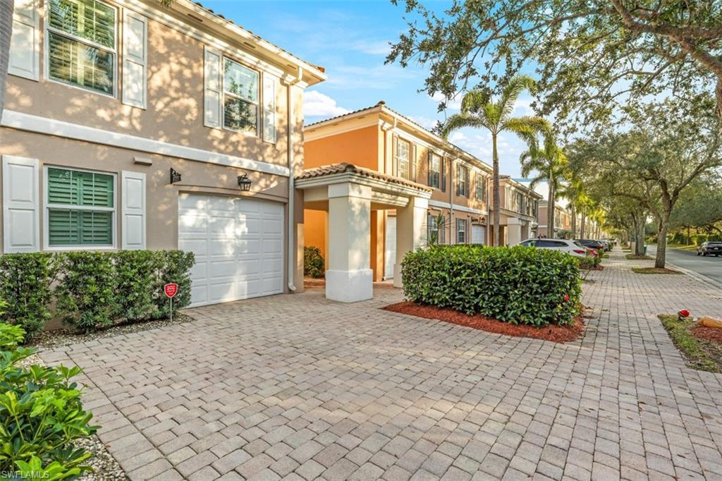 5721 Cove Circle, Unit 36 Naples, FL 34119 - Photo 2 of 32 a front view of a building with garden