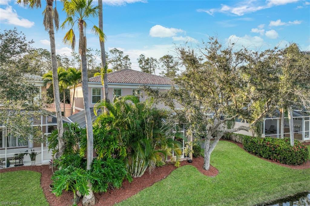 5721 Cove Circle, Unit 36 Naples, FL 34119 - Photo 25 of 32 a aerial view of a house with a yard and potted plants
