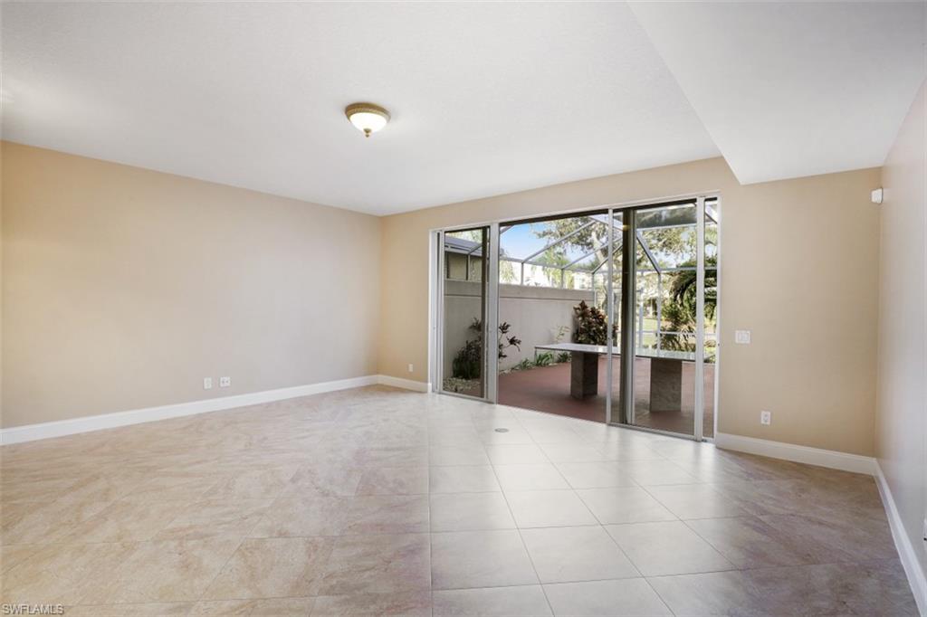 5721 Cove Circle, Unit 36 Naples, FL 34119 - Photo 4 of 32 a view of a livingroom with furniture and floor to ceiling window