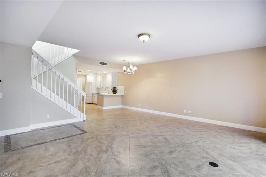 5721 Cove Circle, Unit 36 Naples, FL 34119 - Photo 5 of 32 a view of a hallway with staircase