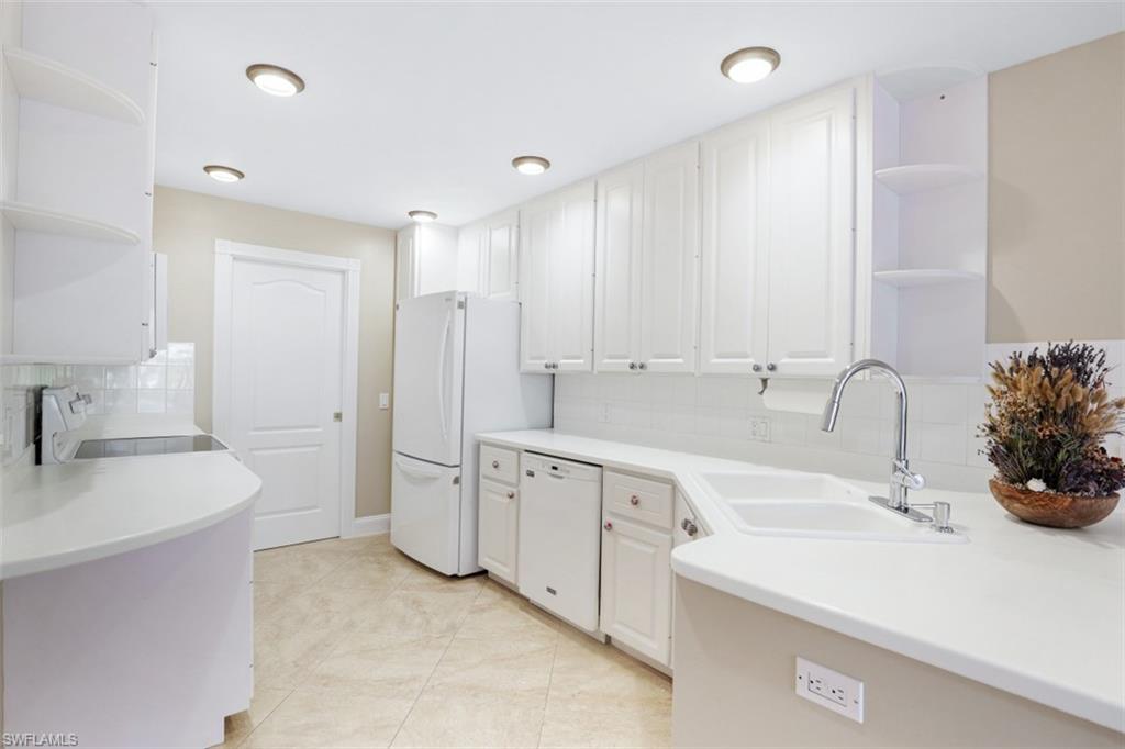 5721 Cove Circle, Unit 36 Naples, FL 34119 - Photo 7 of 32 a spacious bathroom with double sink and a bathtub