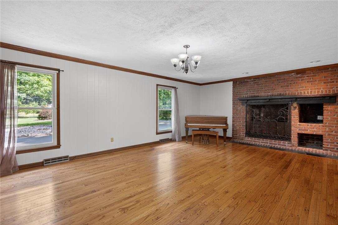 1371 Stoke Park Road Bethlehem, PA 18017 - Photo 18 of 55 Hardwood floors and a commanding brick fireplace anchor this living space.