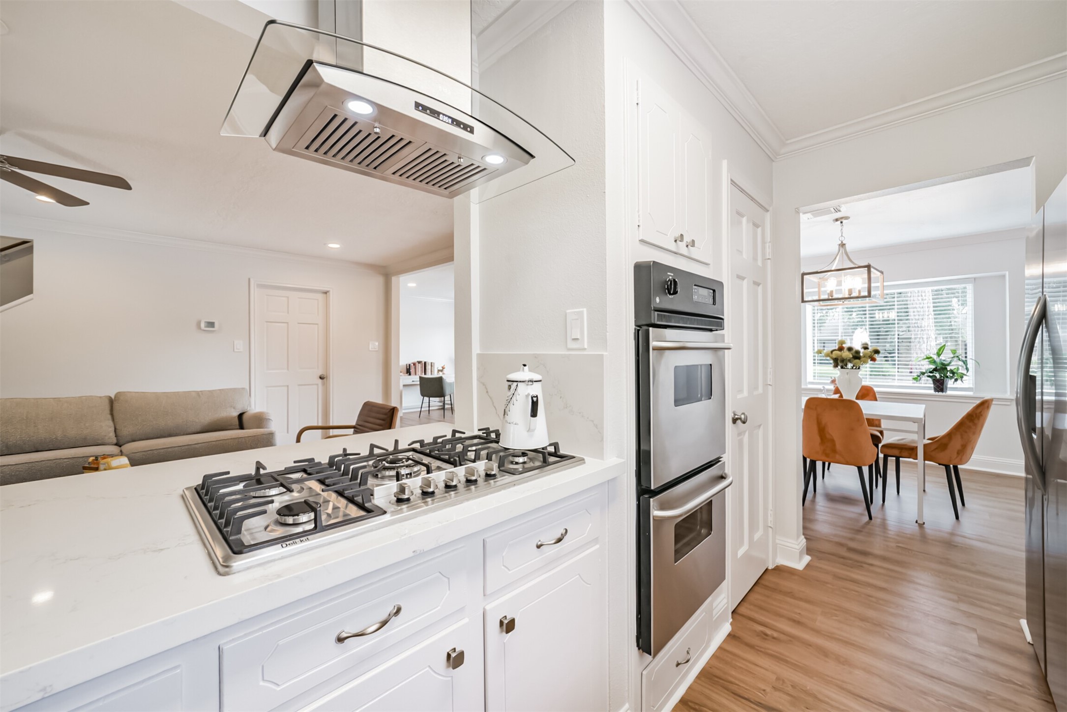 3319 Springrock Lane Houston, TX 77080 - Photo 10 of 41 a kitchen with stainless steel appliances granite countertop a refrigerator a stove and a dining table with wooden floor
