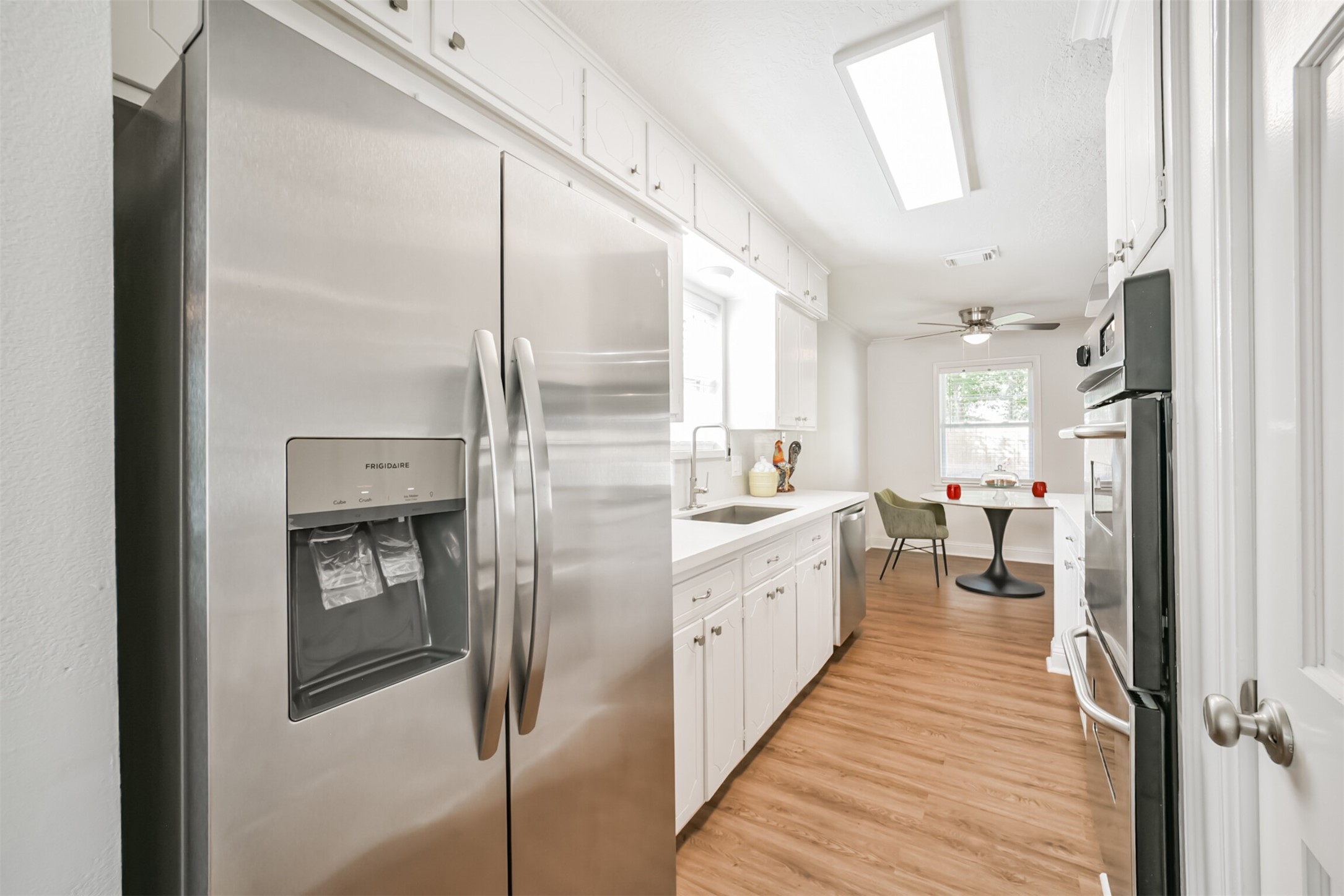 3319 Springrock Lane Houston, TX 77080 - Photo 13 of 41 a large white kitchen with a sink and refrigerator