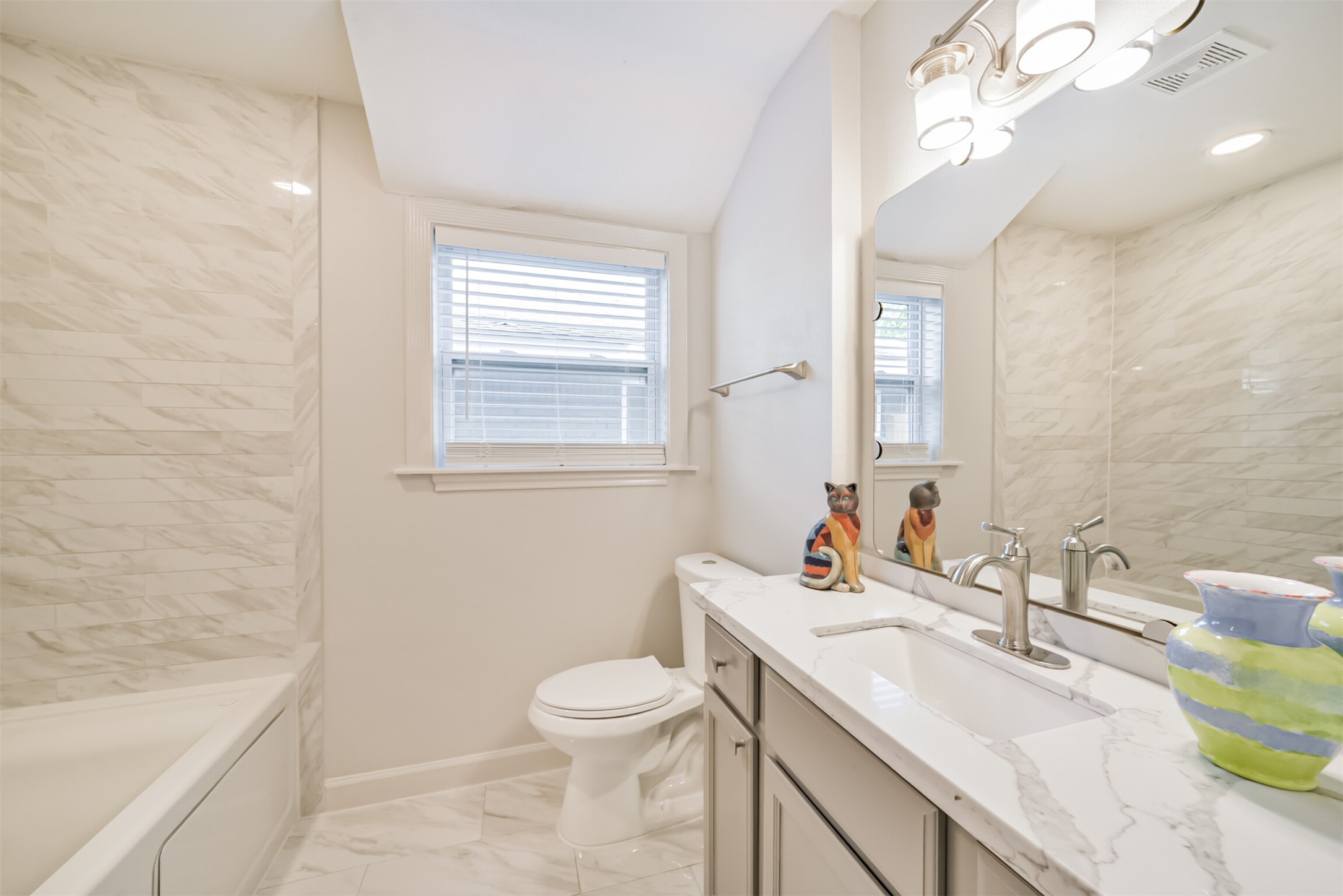 3319 Springrock Lane Houston, TX 77080 - Photo 22 of 41 a bathroom with a sink a toilet a mirror and vanity
