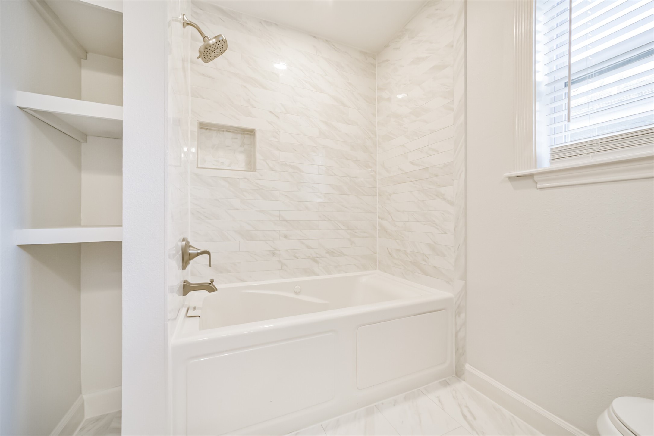 3319 Springrock Lane Houston, TX 77080 - Photo 24 of 41 a white bath tub sitting next to a white toilet