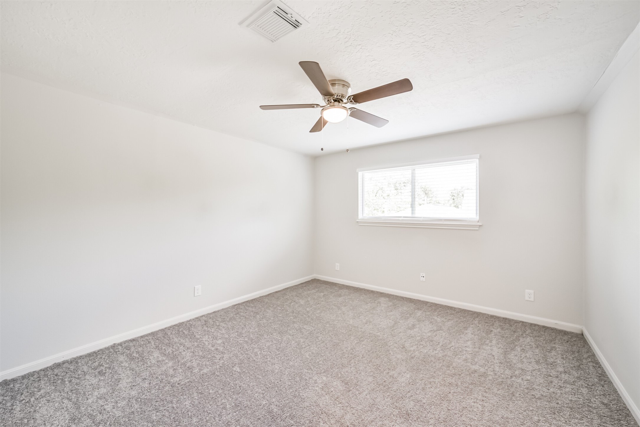 3319 Springrock Lane Houston, TX 77080 - Photo 28 of 41 an empty room with a window and a fan
