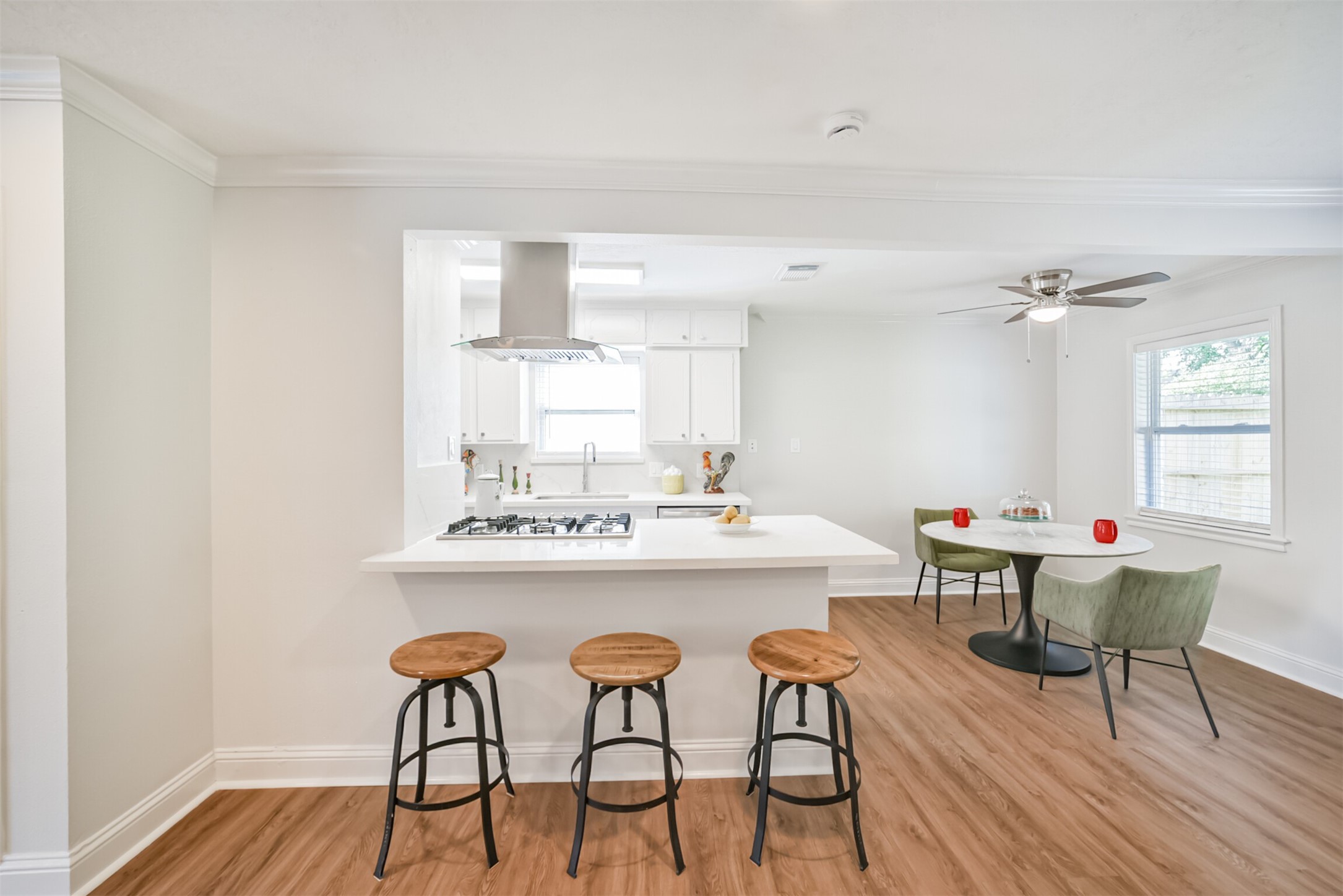 3319 Springrock Lane Houston, TX 77080 - Photo 5 of 41 a kitchen with a dining table chairs and white cabinets