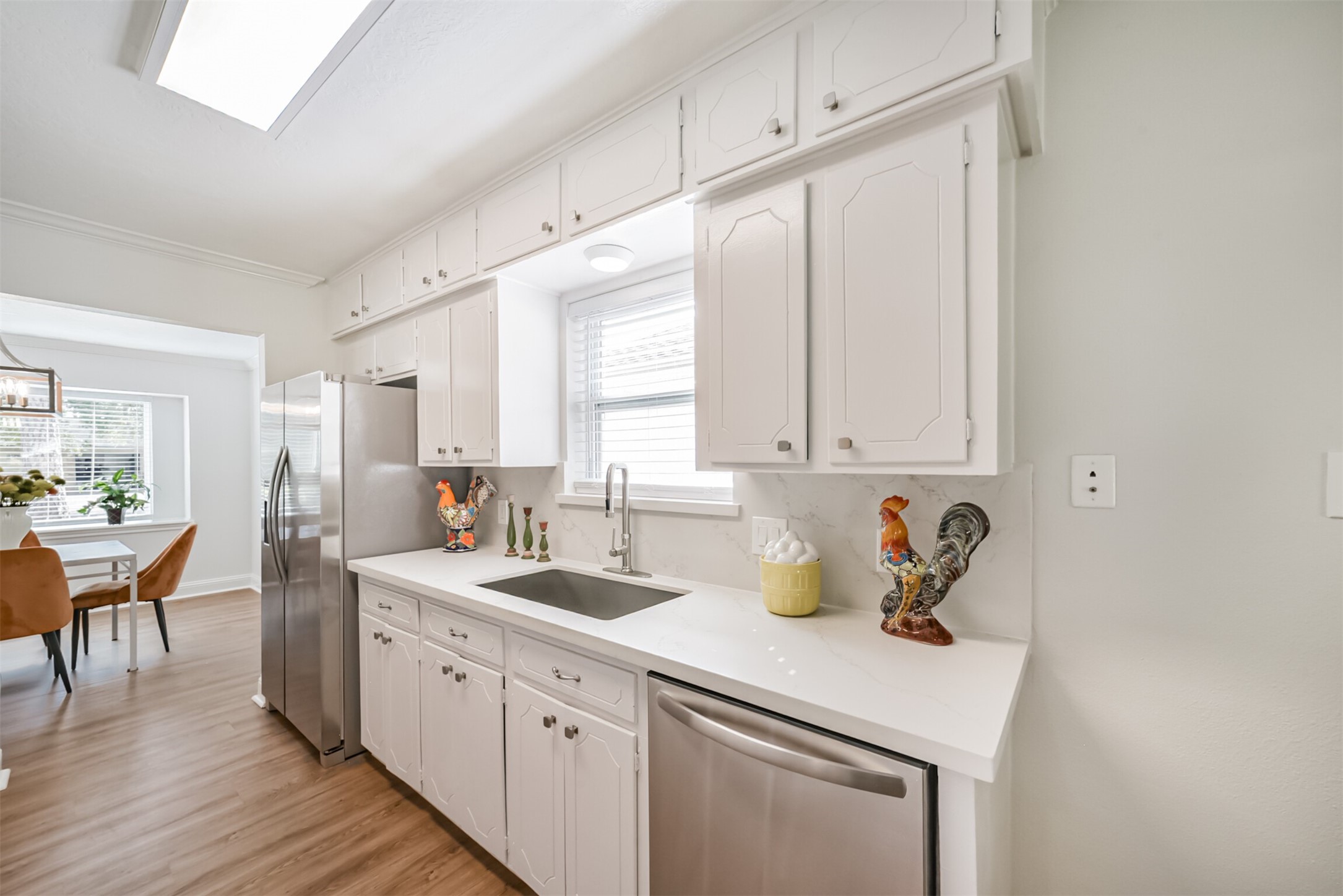 3319 Springrock Lane Houston, TX 77080 - Photo 9 of 41 a kitchen with a sink cabinets and wooden floor