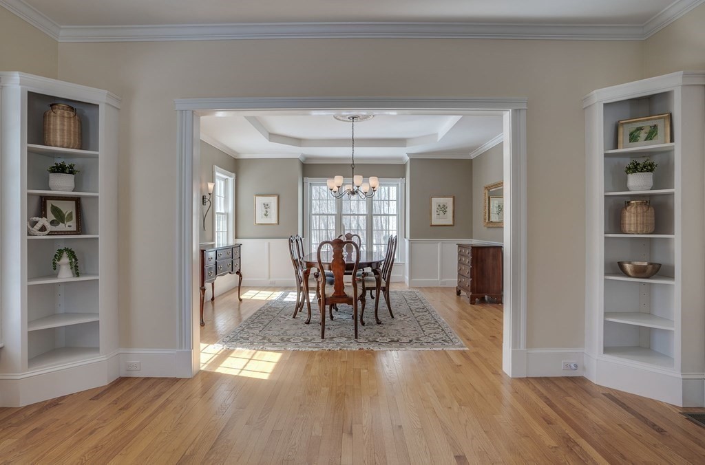 26 Coventry Road Atkinson, NH 03811 - Photo 13 of 42 a dining room with wooden floor a chandelier a glass table and chairs
