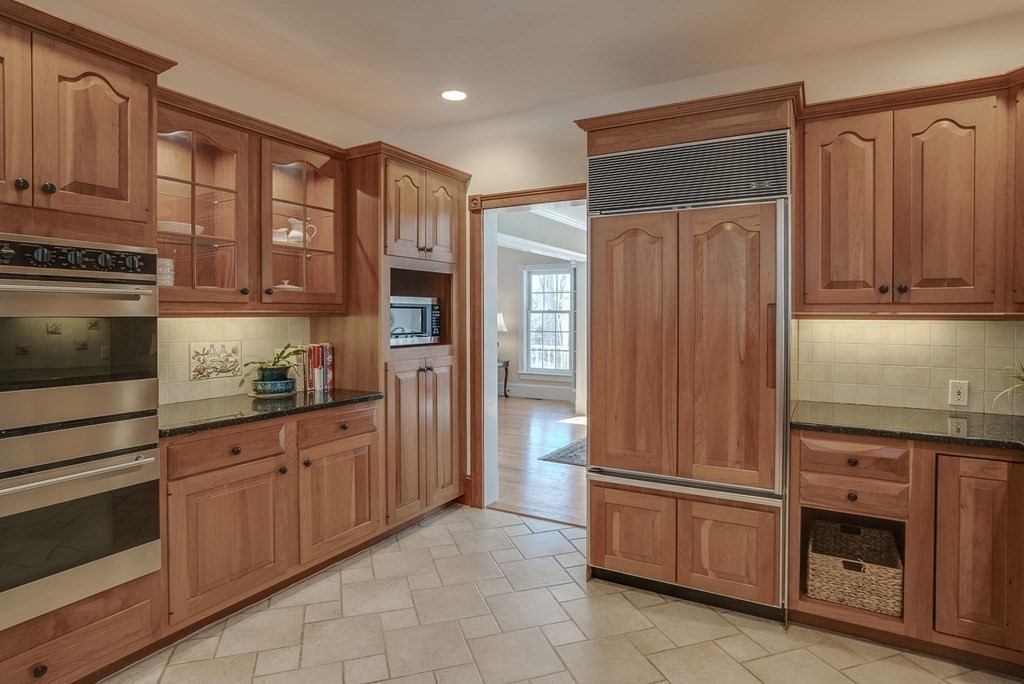 26 Coventry Road Atkinson, NH 03811 - Photo 17 of 42 a kitchen with stainless steel appliances granite countertop a refrigerator and cabinets