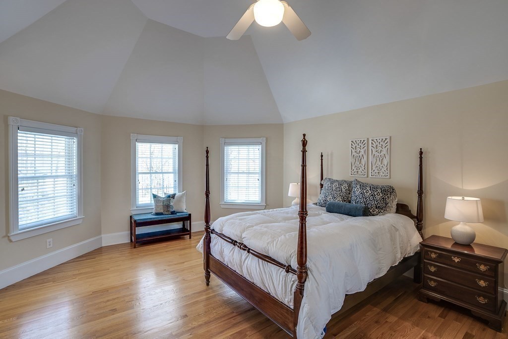 26 Coventry Road Atkinson, NH 03811 - Photo 36 of 42 a bedroom with a bed a chandelier and dresser