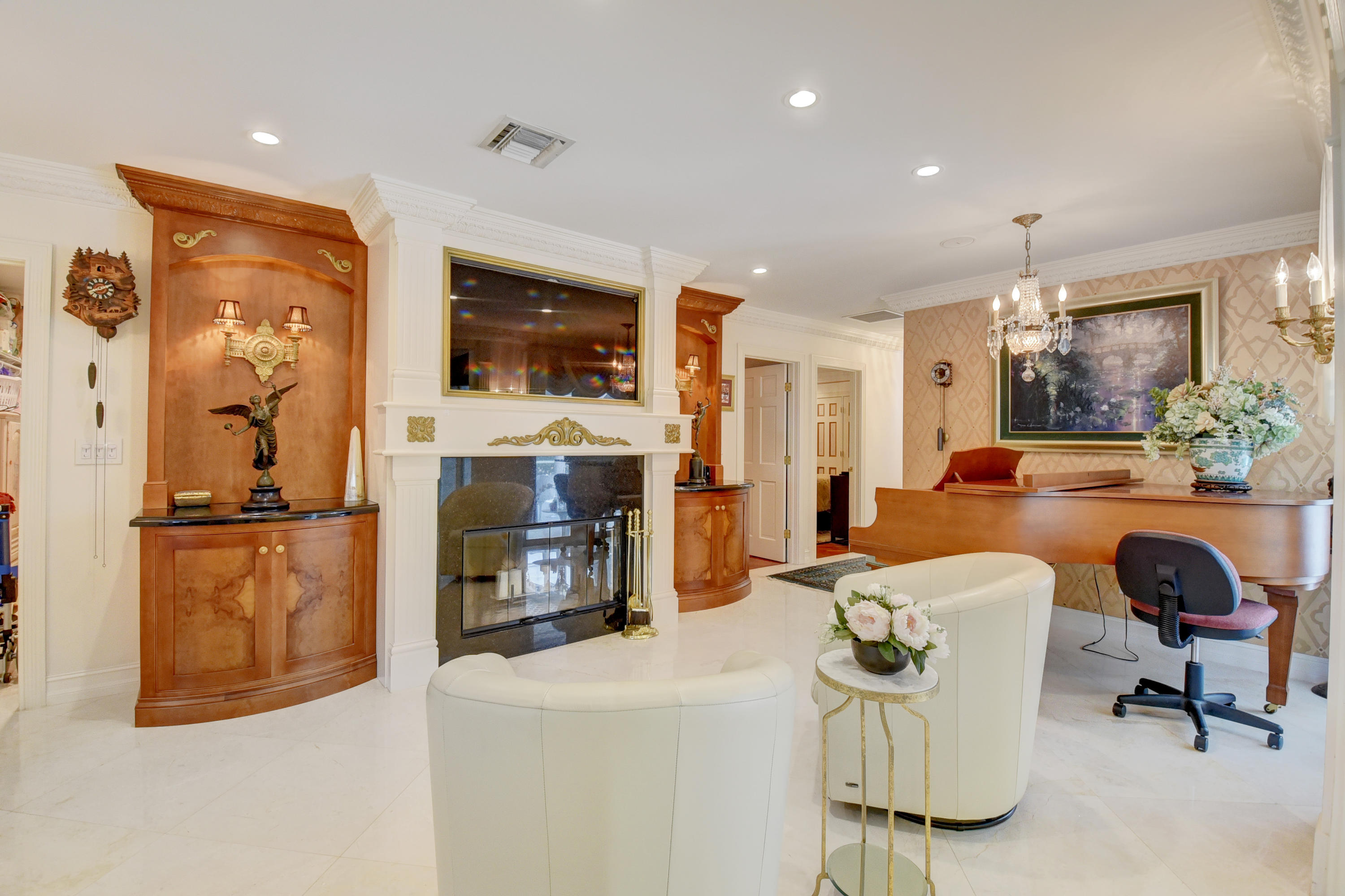 6318 Woodbury Road Boca Raton, FL 33433 - Photo 11 of 52 a living room with fireplace furniture and a flat screen tv