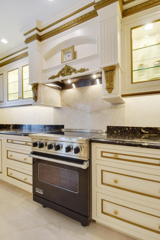 6318 Woodbury Road Boca Raton, FL 33433 - Photo 12 of 52 a stove top oven sitting inside of a kitchen