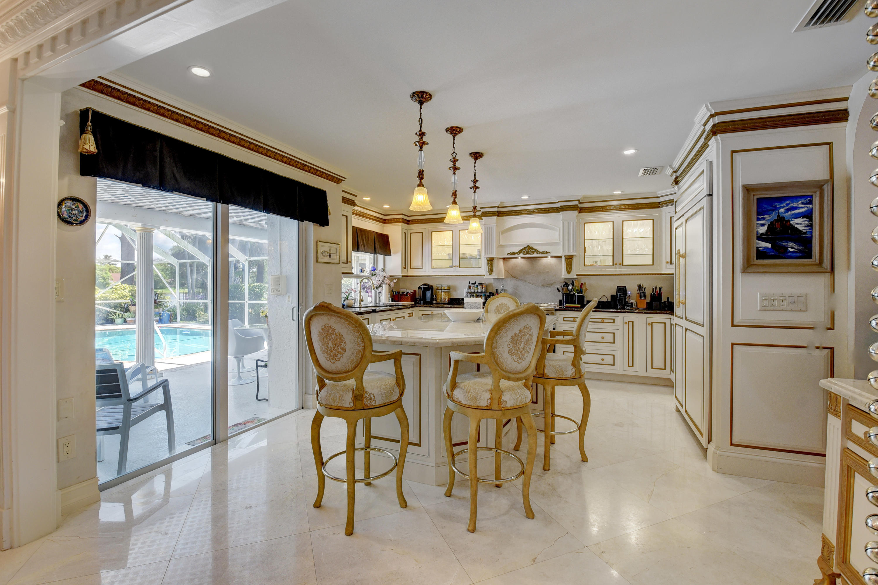 6318 Woodbury Road Boca Raton, FL 33433 - Photo 13 of 52 a kitchen with stainless steel appliances kitchen island granite countertop a refrigerator and microwave