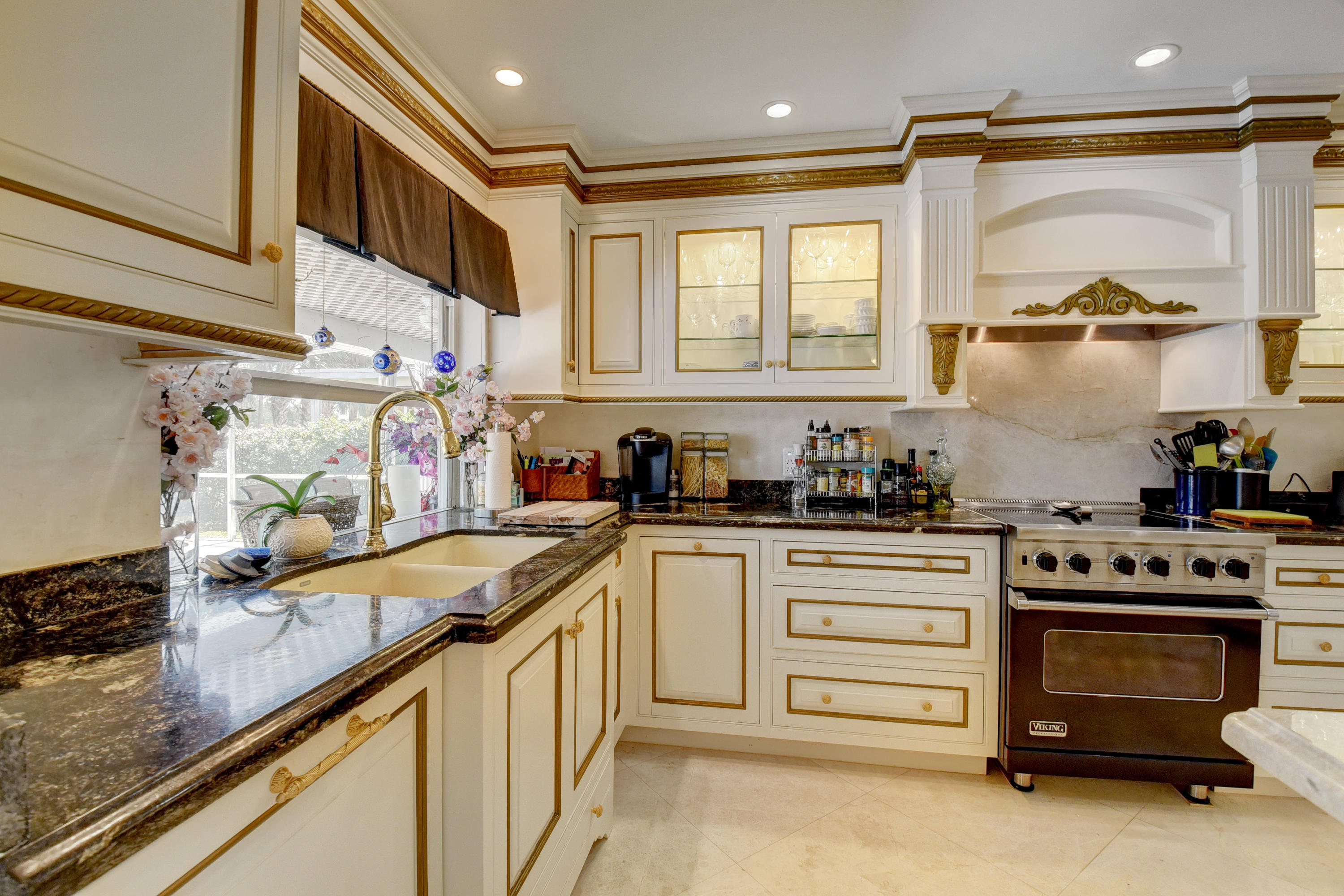 6318 Woodbury Road Boca Raton, FL 33433 - Photo 15 of 52 a kitchen with granite countertop a sink stainless steel appliances and cabinets