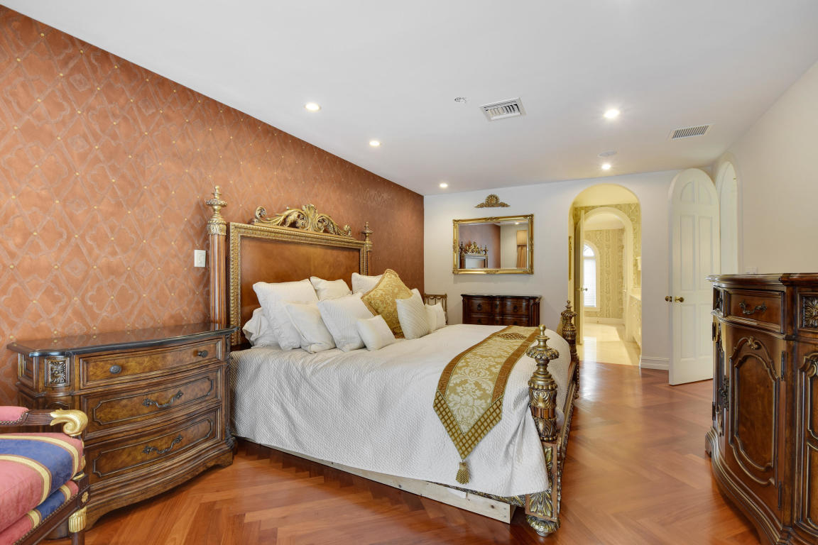 6318 Woodbury Road Boca Raton, FL 33433 - Photo 18 of 52 a spacious bedroom with a bed and a mirror