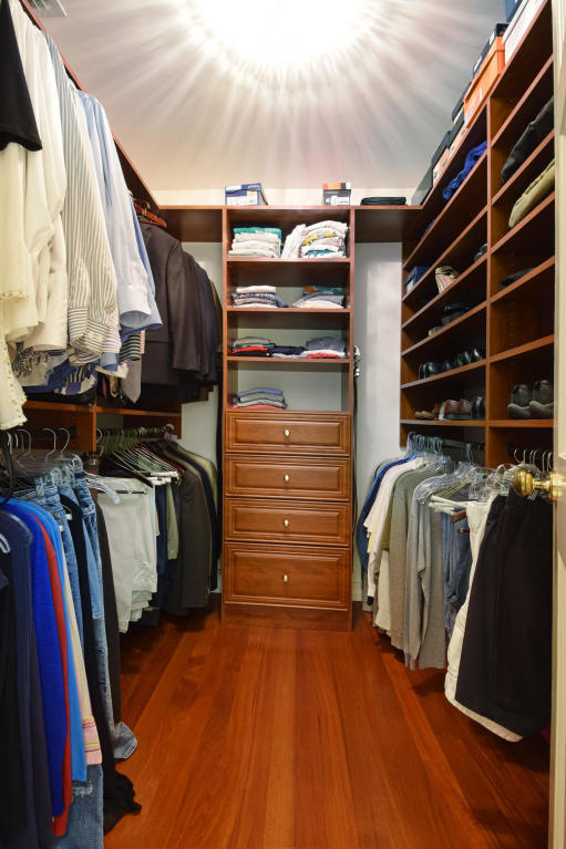 6318 Woodbury Road Boca Raton, FL 33433 - Photo 21 of 52 a view of walk in closet with clothes and shoes
